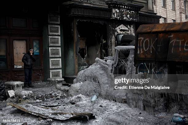 Charred police truck covered with ice has become part of the protester's barricade on January 28, 2014 in Kiev, Ukraine. While Ukrainian parliament...