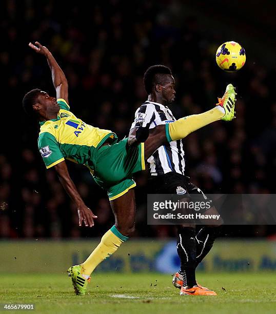 Cheick Tiote of Newcastle in action with Sebastien Bassong of Norwich during the Barclays Premier League match between Norwich City and Newcastle...