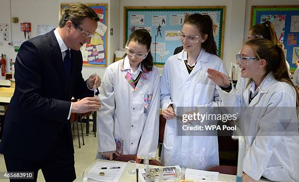 Prime Minister David Cameron meets pupils and observes a science lesson during a visit to the Green School For Girls with education secretary Nicky...