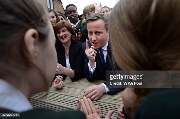 Prime Minister David Cameron and education secretary Nicky Morgan meet pupils during a visit to the Green School For Girls on March 9, 2015 in...