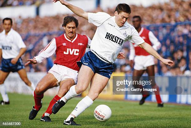 Spurs winger Chris Waddle holds off the challenge of Kenny Sansom during a First Division Match between Tottenham Hotspur and Arsenal at White Hart...