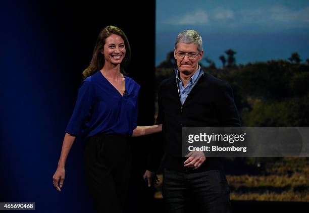 Model Christy Turlington Burns, left, stands with Tim Cook, chief executive officer of Apple Inc., on stage during the Apple Inc. Spring Forward...