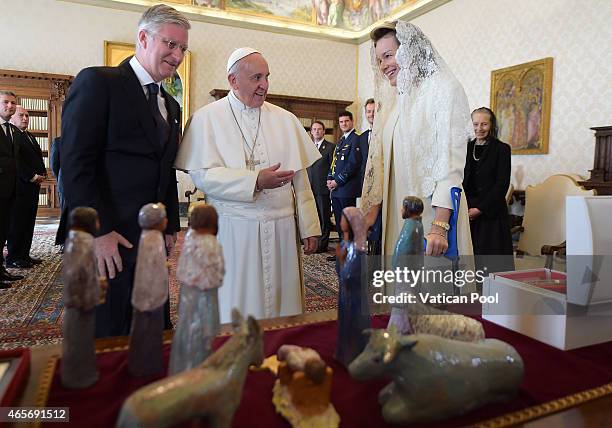 Pope Francis exchanges gifts with King Philippe of Belgium and Queen Mathilde of Belgium at his private library in the Apostolic Palace on March 9,...