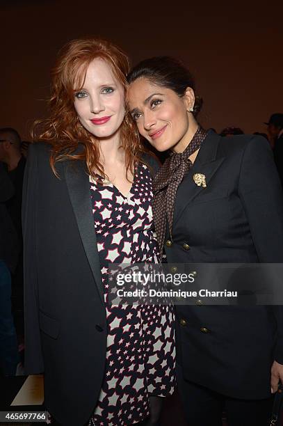 Jessica Chastain and Salma Hayek attend the Saint Laurent show as part of the Paris Fashion Week Womenswear Fall/Winter 2015/2016 on March 9, 2015 in...