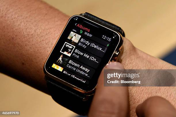 An attendee demonstrates the Apple Watch Edition for a photograph during the Apple Inc. Spring Forward event in San Francisco, California, U.S., on...