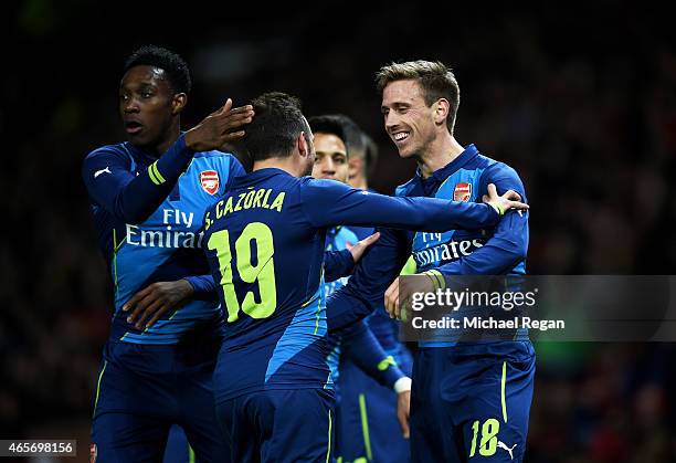 Nacho Monreal of Arsenal celebrates with teammates after scoring the opening goal during the FA Cup Quarter Final match between Manchester United and...