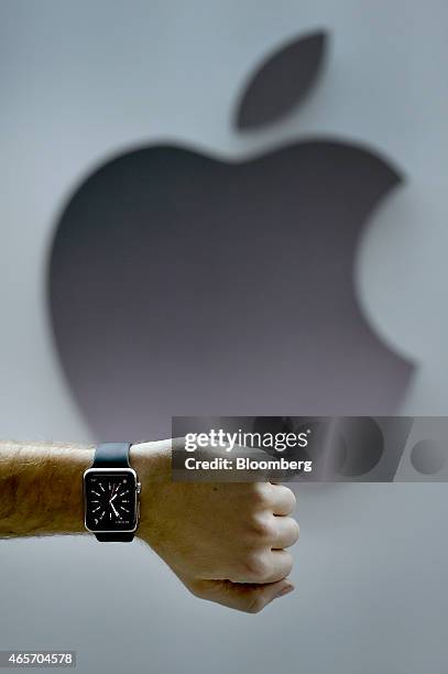 An attendee displays the Apple Watch for a photograph during the Apple Inc. Spring Forward event in San Francisco, California, U.S., on Monday, March...