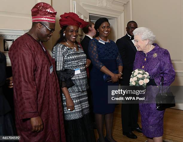 Queen Elizabeth II speaks with guests during a reception to mark Commonwealth Day at Marlborough House on March 9, 2015 in London, England.