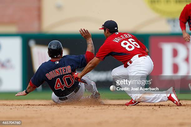 Humberto Quintero of the Boston Red Sox steals second base as Breyvic Valera of the St Louis Cardinals is unable to hold onto the ball in the eighth...