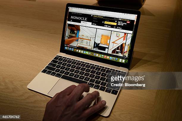 An attendee demonstrates the Apple Inc. Macbook laptop during the company's Spring Forward event in San Francisco, California, U.S., on Monday, March...