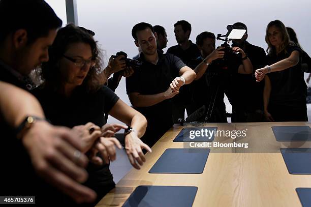 Attendees try on the Apple Watch during the Apple Inc. Spring Forward event in San Francisco, California, U.S., on Monday, March 9, 2015. Apple Inc....