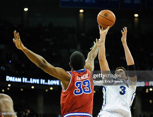 Doug McDermott of the Creighton Bluejays shoots over Orlando Sanchez of the St. John's Red Storm during a game at CenturyLink Center on January 28,...