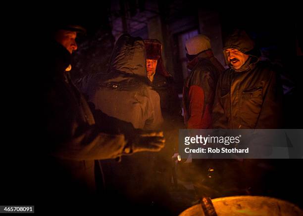 Anti-government protestors gather around a fire in Independence Square on January 29, 2014 in Kiev, Ukraine. Ukraine's parliament is holding a...