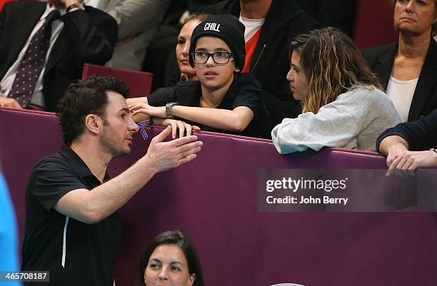 Michael Youn talks with his girlfriend Isabelle Funaro and her son Sean during the Amelie Mauresmo Tennis Night to benefit the 'Institut Curie' to...