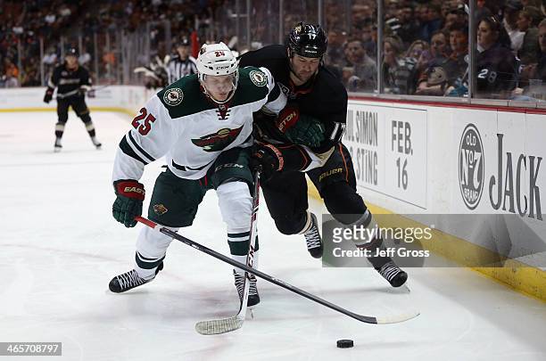 Jonas Brodin of the Minnesota Wild and Dustin Penner of the Anaheim Ducks fight for the puck in the third period at Honda Center on January 28, 2014...