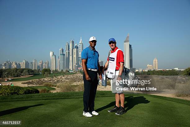 Tiger Woods of the USA poses with his caddie Joe LaCava on the eighth tee during the pro-am as a preview for the 2014 Omega Dersert Classic on the...