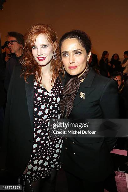 Jessica Chastain and Salma Hayek attend the Saint Laurent show as part of the Paris Fashion Week Womenswear Fall/Winter 2015/2016 on March 9, 2015 in...