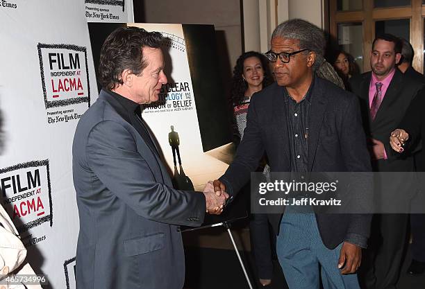 Film Independent Curator Elvis Mitchell shakes the hand of author Lawrence Wright at Film Independent at LACMA screening and Q&A of HBO Documentary...