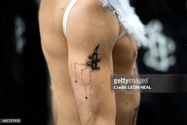 Ballet dancer with Amnesty International logo painted on his arm takes part in a protest near to the Russian embassy in London on January 29...