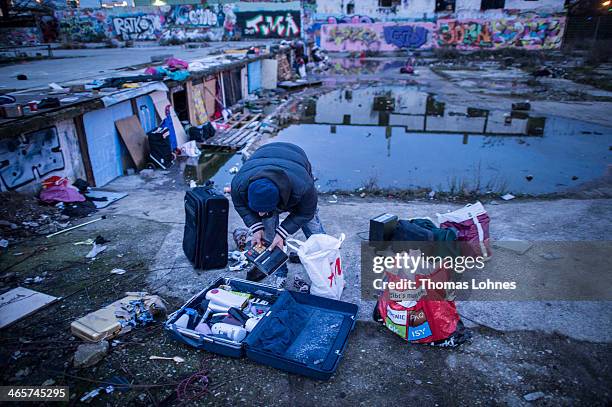 Romanian immigrant sorts the cheap thinks he found in the trash next to the slab of concrete he calls home on an abandoned industrial property on...