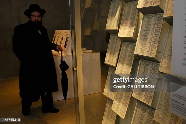 An Ultra-Orthodox Jewish man looks at facsimiles of Oskar Schindler's lists displayed for the public at the Yad Vashem Holocaust memorial museum in...