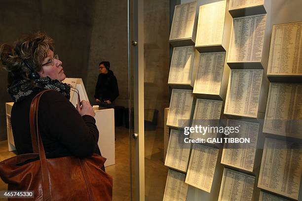 Woman looks at facsimiles of Oskar Schindler's lists displayed for the public at the Yad Vashem Holocaust memorial museum in Jerusalem, where the...