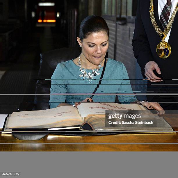 Crown Princess Victoria of Sweden reacts as she signs the 'steelbook' of Essen during her visit in North Rhine-Westphalia at Zeche Zollverein on...