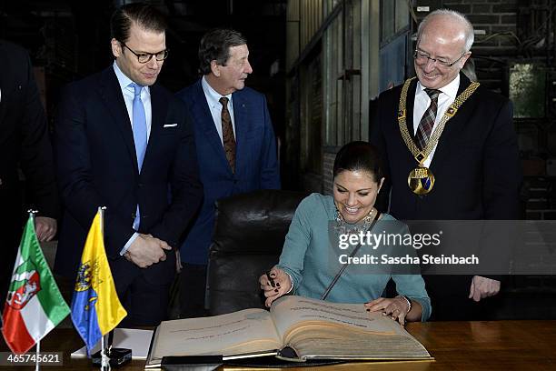 Crown Princess Victoria of Sweden and Prince Daniel of Sweden sign the 'steelbook' of Essen as mayor Reinhard Pass looks on during their visit in...