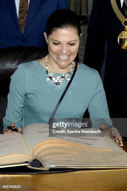 Crown Princess Victoria of Sweden reacts as she signs the 'steelbook' of Essen during her visit in North Rhine-Westphalia at Zeche Zollverein on...