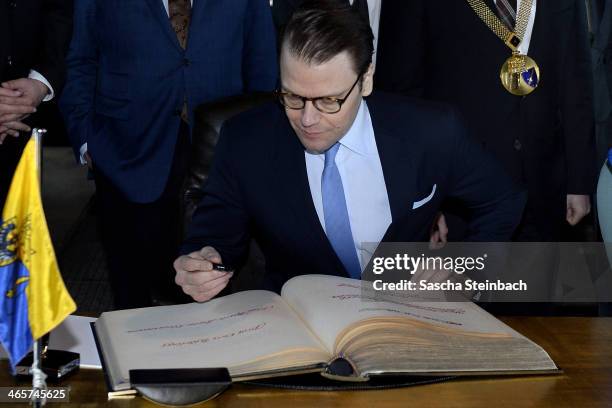 Prince Daniel of Sweden signs the 'steelbook' of Essen during his visit in North Rhine-Westphalia at Zeche Zollverein on January 29, 2014 in Essen,...