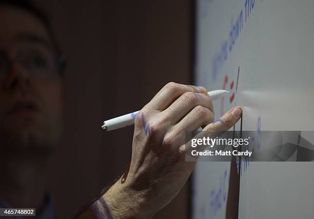 Teacher talks to pupils during a maths lesson at the Ridings Federation Winterbourne International Academy in Winterbourne near Bristol on February...