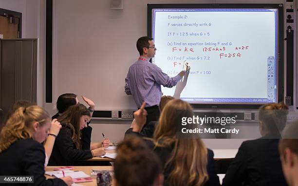 Teacher talks to pupils during a maths lesson at the Ridings Federation Winterbourne International Academy in Winterbourne near Bristol on February...