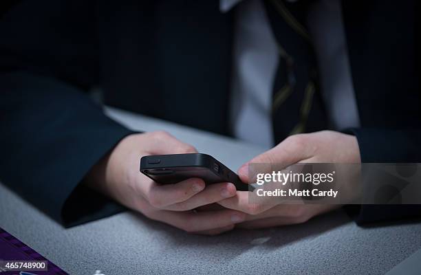 Pupil uses his mobile phone for research during a english lesson at the Ridings Federation Winterbourne International Academy in Winterbourne near...