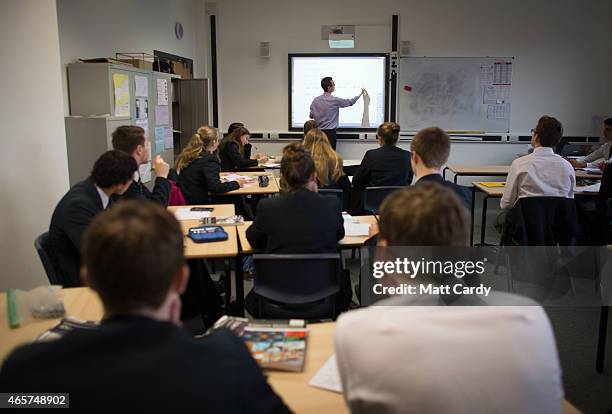 Teacher talks to pupils during a maths lesson at the Ridings Federation Winterbourne International Academy in Winterbourne near Bristol on February...