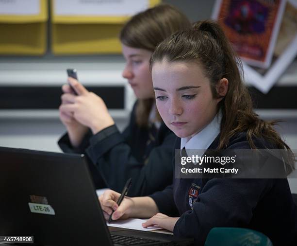 Pupil uses a laptop computer during a english lesson at the Ridings Federation Winterbourne International Academy in Winterbourne near Bristol on...