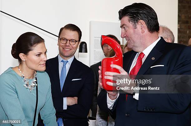 Crown Princess Victoria of Sweden and Prince Daniel of Sweden look on to a fire-extinguisher during their visit of the special exhibition 'Sweden at...
