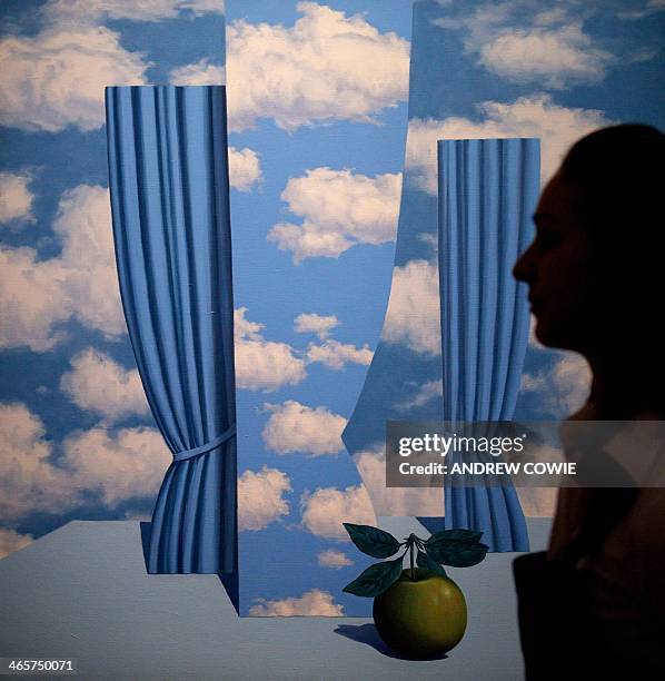 Sotheby's employee stands in front of Rene Magritte's "Le Beau Monde" during the Sotheby's Impressionist, Modern & Contemporary Art auctions press...