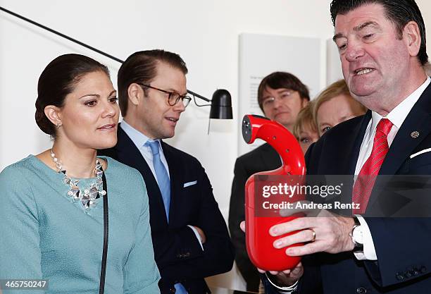 Crown Princess Victoria of Sweden and Prince Daniel of Sweden look on to a fire-extinguisher during their visit of the special exhibition 'Sweden at...