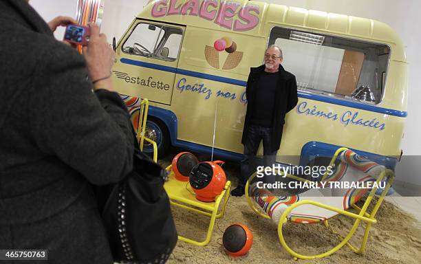 Man poses for a photo in front of a a Renault Estafette model van manufactured at the Sandouville site of French automobile manufacturer Renault,...