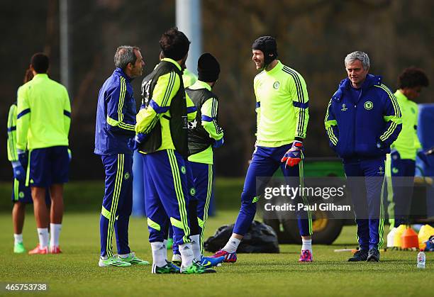 Jose Mourinho manager of Chelsea and goalkeeper Petr Cech smile alongside staff and team mates during a Chelsea training session ahead of the UEFA...