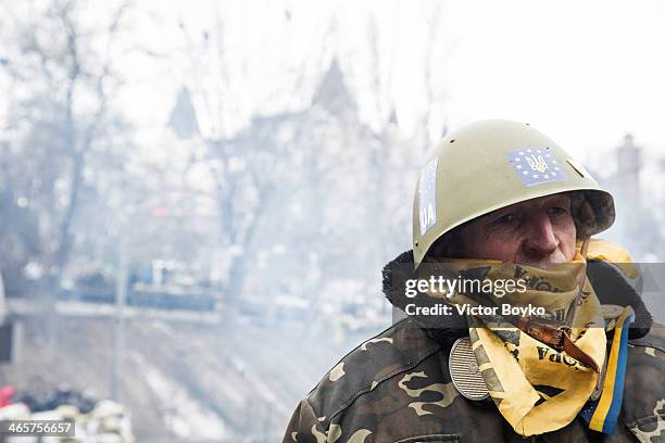 Protester stands on guard of the barricade on Grushevskogo Street on January 28, 2014 in Kiev, Ukraine. Ukraine's President Viktor Yanukovych has...