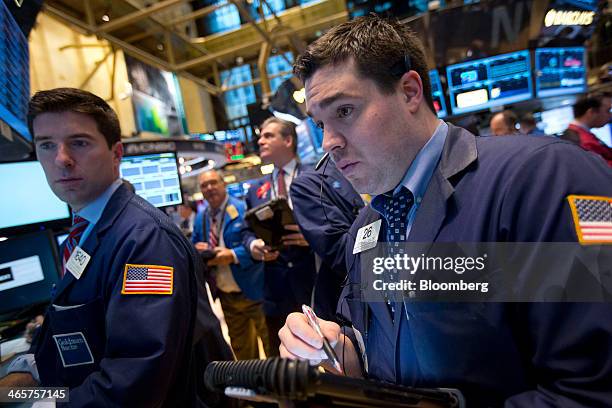 Traders work on the floor of the New York Stock Exchange in New York, U.S., on Wednesday, Jan. 30, 2014. U.S. Stocks fell, erasing yesterday's gains,...
