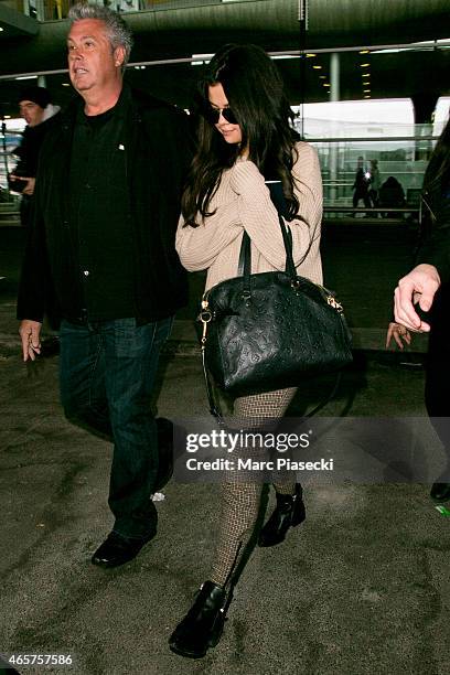 Actress and singer Selena Gomez arrives at Charles-de-Gaulle airport during the Paris Fashion Week Fall Winter 2015/2016 on March 10, 2015 in Paris,...