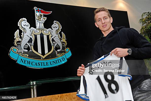 New Signing Luuk de Jong holds his new number 18 shirt in front of the club crest at St.James' Park on January 29 in Newcastle upon Tyne, England.