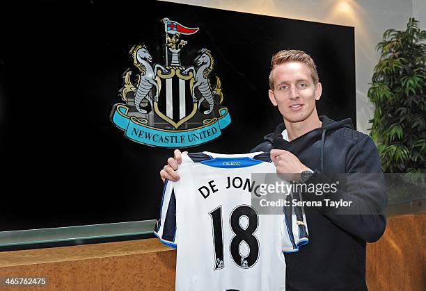 New Signing Luuk de Jong holds his new number 18 shirt in front of the club crest at St.James' Park on January 29 in Newcastle upon Tyne, England.