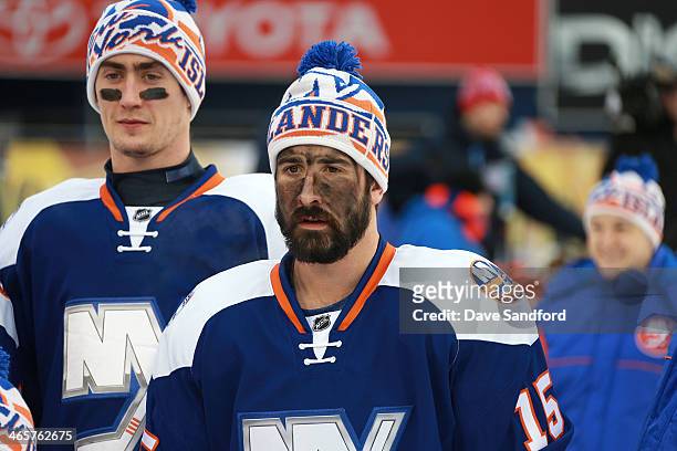 Brock Nelson and Cal Clutterbuck of the New York Islanders pose with teammates for a team photo during the 2014 NHL Stadium Series family skate at...