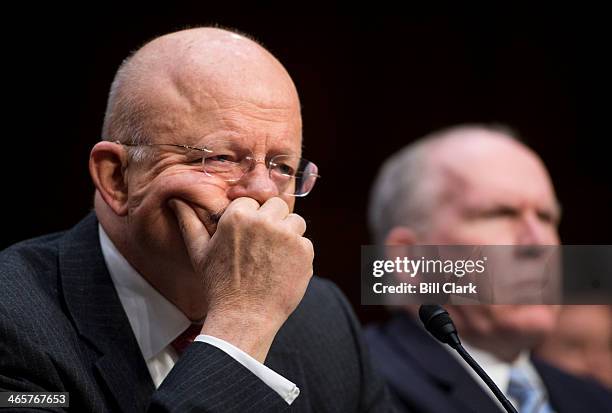 Director of National Intelligence James Clapper, left, and CIA Director John Brennan testify during the Senate Intelligence Committee hearing on...
