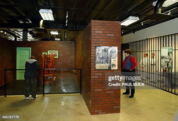 Visitors browse the exhibits at the Texas Prison Museum in Huntsville, Texas 07 December 2002. At left is "Old Sparky" the electric chair used from...