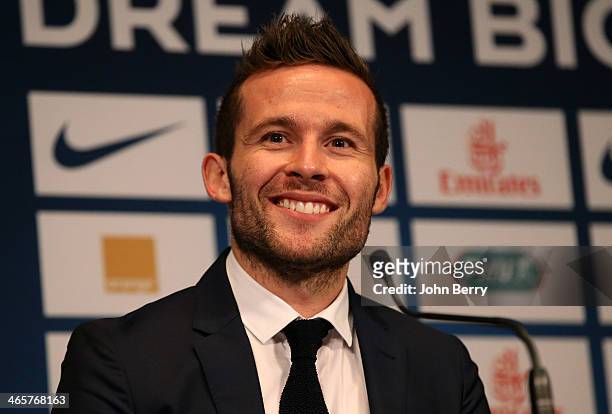 Yohan Cabaye is presented by Nasser Al-Khelaifi, president of Paris Saint-Germain as a new player of PSG during a press conference with a jersey...