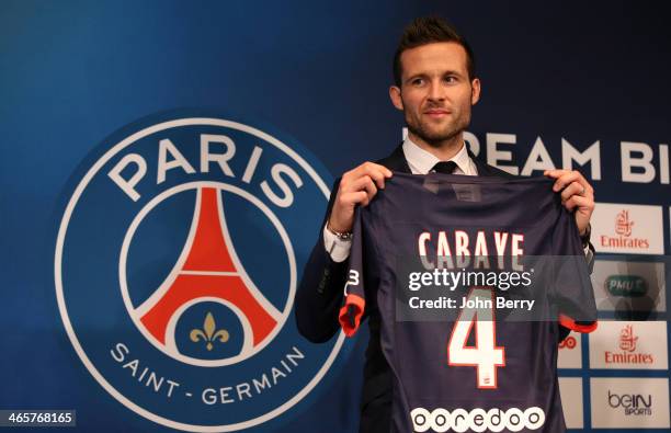 Yohan Cabaye is presented by Nasser Al-Khelaifi, president of Paris Saint-Germain as a new player of PSG during a press conference with a jersey...